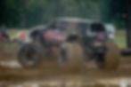 Close-up view of a monster truck crushing cars during a freestyle event