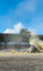 Jekyll & Hyde jumping over bounty hunter monster truck side view 